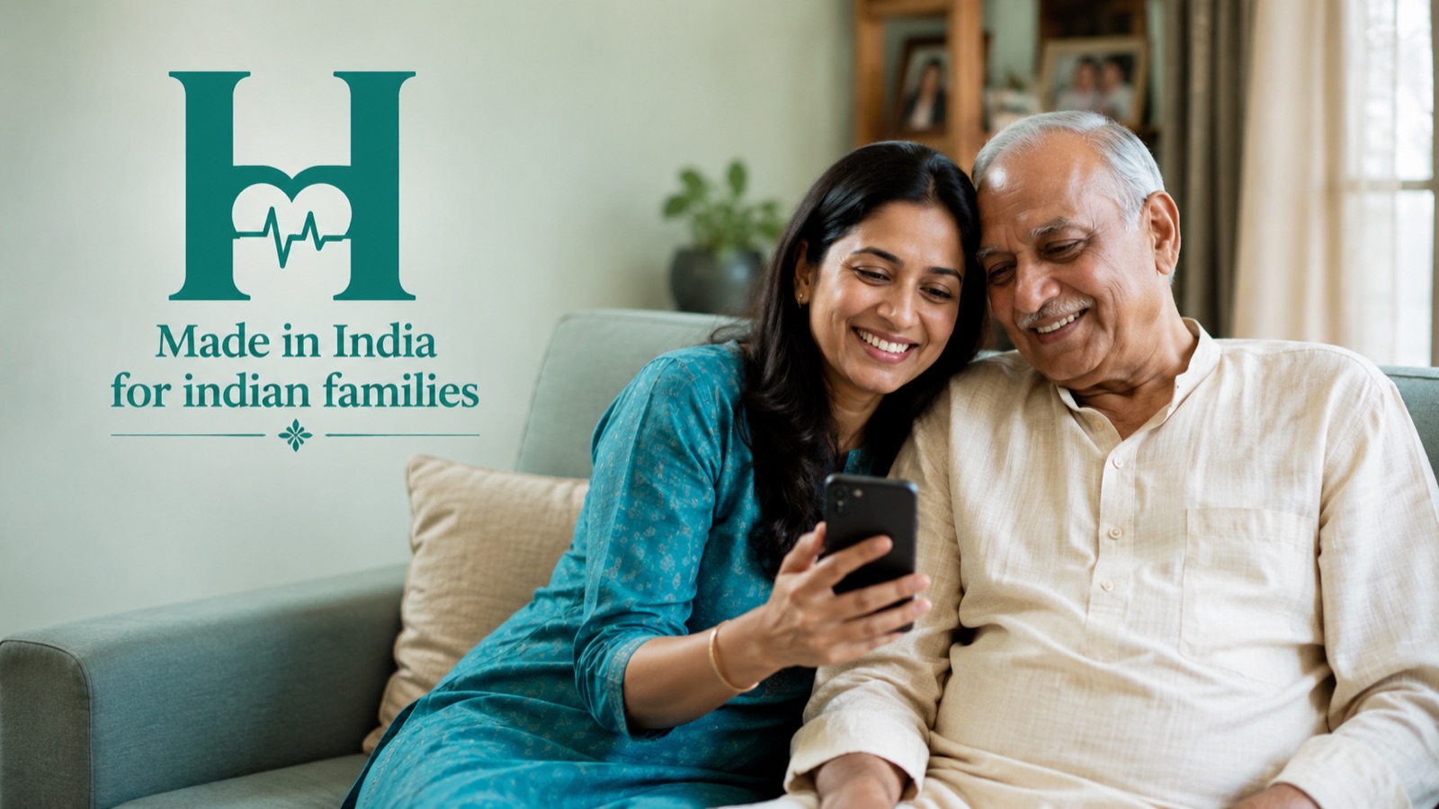 An Indian daughter and her elderly father smiling together while looking at the Healmory app on a phone.